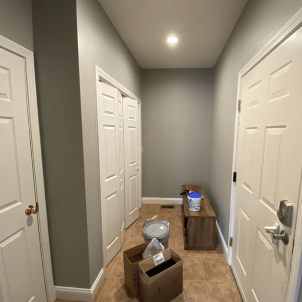 A hallway inside a residential home was neatly painted a shade of gray.
